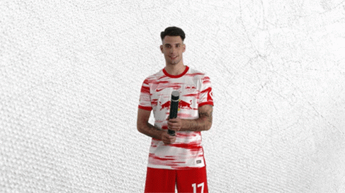 Man in Red and White Jersey With Bull