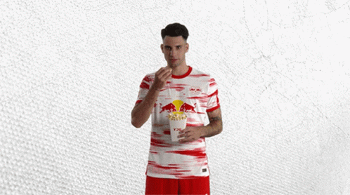 Man in Red and White Jersey With Bull
