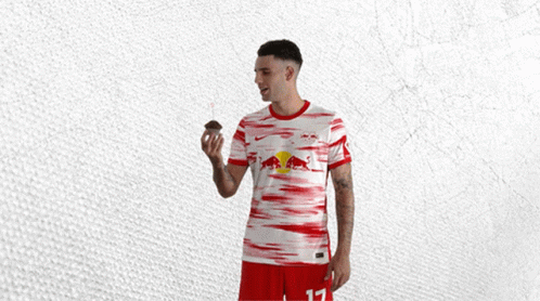 Man in Red and White Jersey With Bull