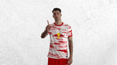 Man in Red and White Jersey With Red Bull
