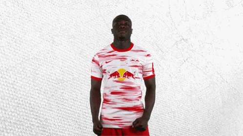 Man in Red and White Jersey With Red Bull