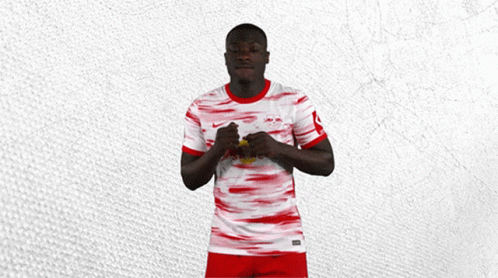 Man in Red and White Jersey With Red Bull