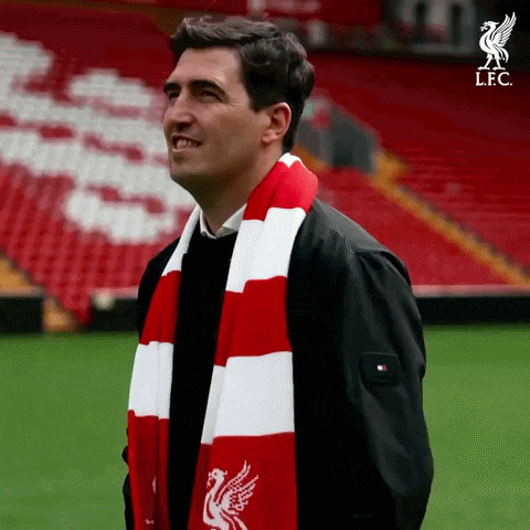 Man In Red And White Scarf With Liverpool Logo GIF