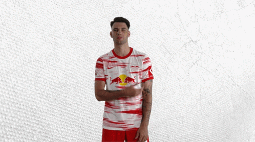 Man in Red and White Shirt With Bull