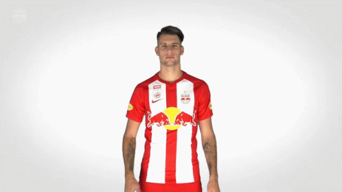 Man in Red and White Shirt With Red Bull
