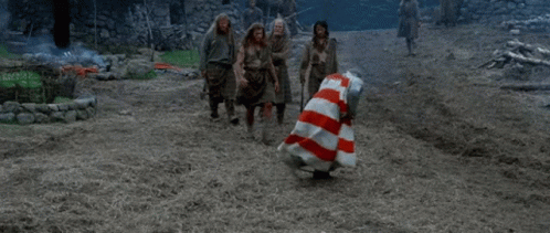 Man in Red and White Striped Dress Dancing With Others