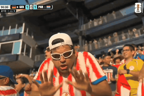 Man in Red and White Striped Shirt Watching GER vs PAR Soccer