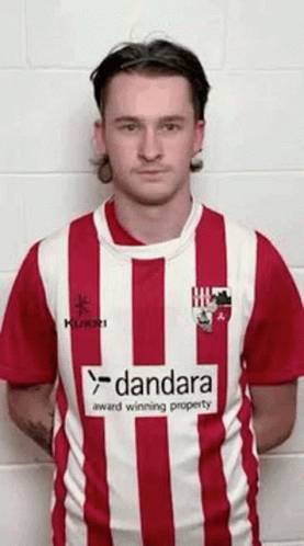 Man in Red and White Striped Shirt with Dandara Logo