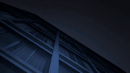 Man In Red And White Suit Hanging From Building At Night GIF