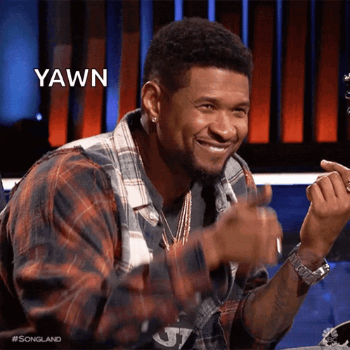 Man In Red And White Sweater Smiling At Table GIF