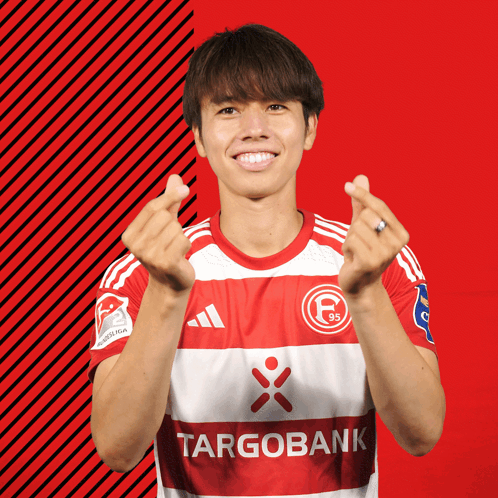 Man In Red And White Targobank Jersey Making Heart Shape GIF