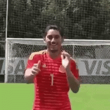 Man in Red and Yellow Striped Shirt at Soccer Goal