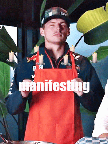 Man in Red Apron Holding Candles Manifesting