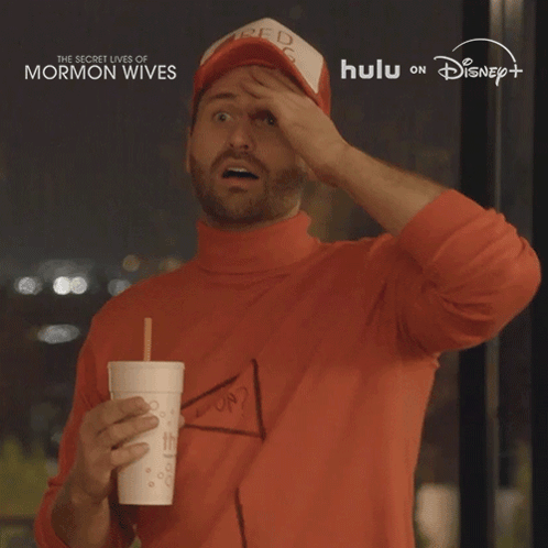 Man in Red Bag Hat Holding Drink