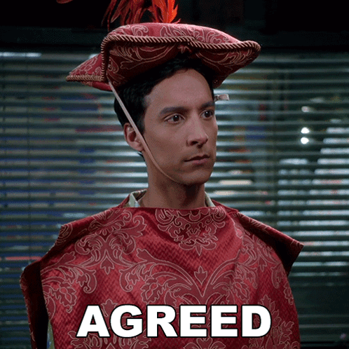 Man in Red Cape and Hat Saying Agreed