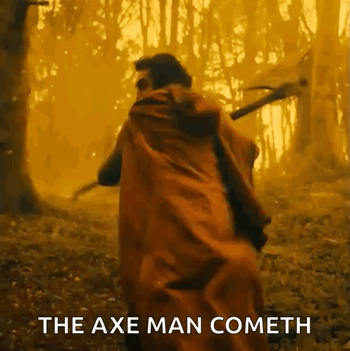 Man In Red Cape Holding Axe In Forest GIF