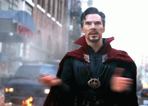 Man In Red Cape In Front Of Lounge Building GIF