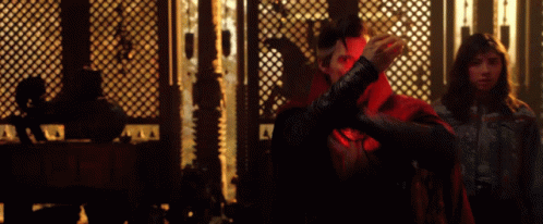 Man In Red Cape Next To Woman GIF