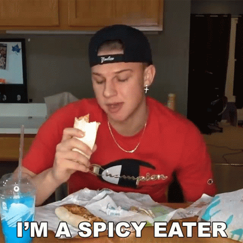 Man in Red Champion Shirt Eating Taco