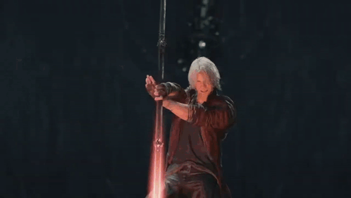 Man in Red Coat Holding Sword Surrounded by Fire