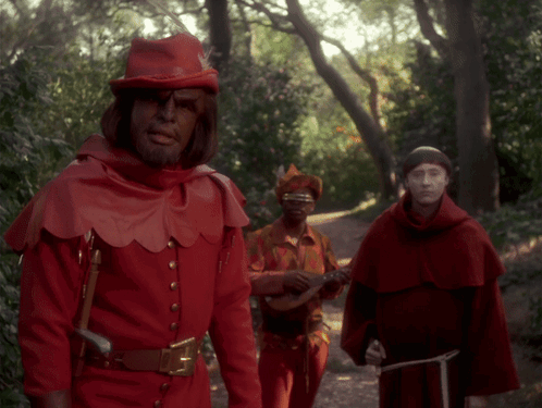 Man in Red Costume Playing Guitar