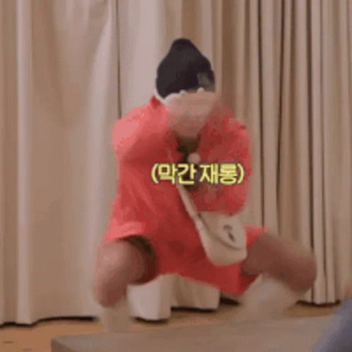 Man in Red Dress and Hat Jumping