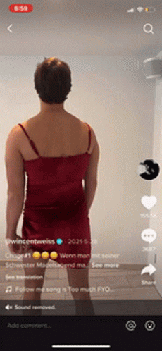 Man In Red Dress Standing In Front Of Wall GIF