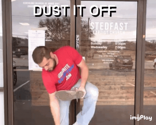 Man in Red Dust It Off Shirt Cleaning Door