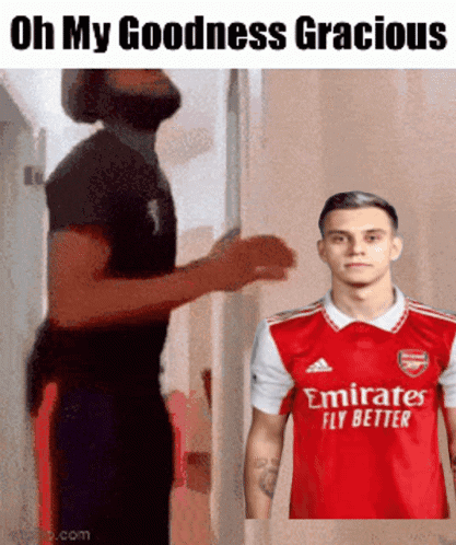 Man in Red Emirates Fly Better Shirt Next to Another Man