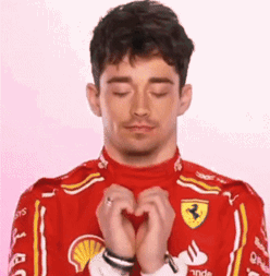 Man in Red Ferrari Suit Making Heart