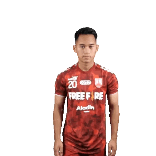 Man in Red Free Fire Shirt Covering Ears
