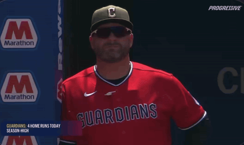 Man in Red Guardians Jersey With Marathon Sign