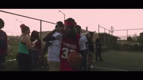 Man In Red Hamilton Jersey Holding Basketball GIF