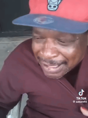Man in Red Hat and Black Shirt Smiling