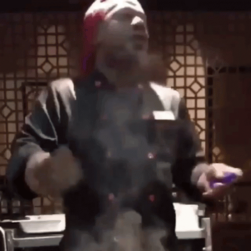 Man in Red Hat and Gloves Cooking