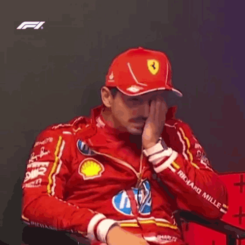 Man in Red Hat and Jacket Sitting