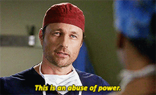 Man in Red Hat and Scrubs Saying This Is an Abuse of Power