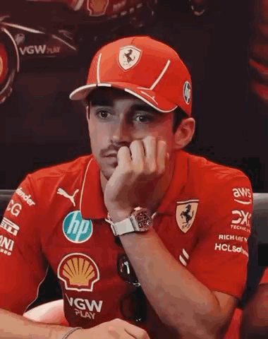 Man in Red Hat and Shirt Sitting