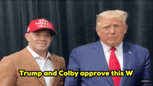 Man In Red Hat And Suit Saying Trump And Colby Approve This W GIF