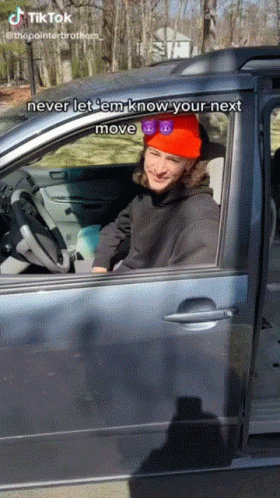 Man in Red Hat and Sunglasses Driving Car