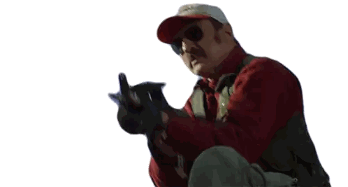 Man in Red Hat and Sunglasses Pointing Gun
