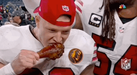 Man in Red Hat Eating Chicken Wing