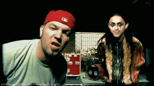 Man In Red Hat Next To Woman GIF