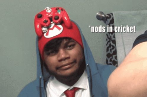 Man in Red Hat Nods in Cricket