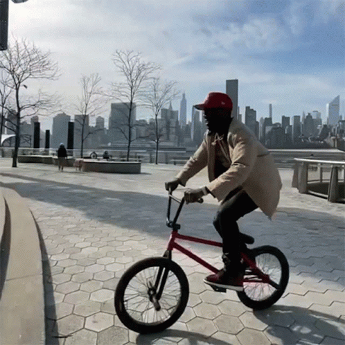 Man in Red Hat Riding Bike