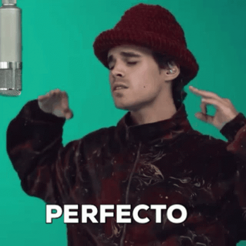 Man in Red Hat Singing Perfecto