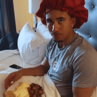 Man in Red Hat Sitting with Food