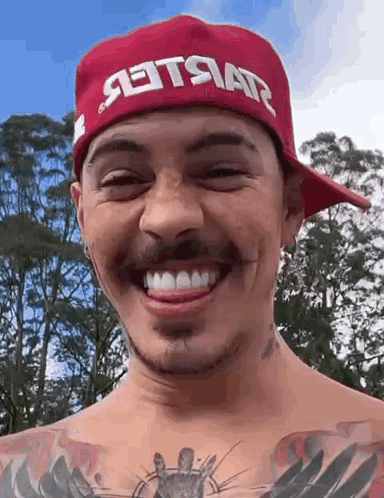 Man in Red Hat Smiling With Tongue Out