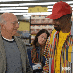 Man in Red Hat Talking to Another Man