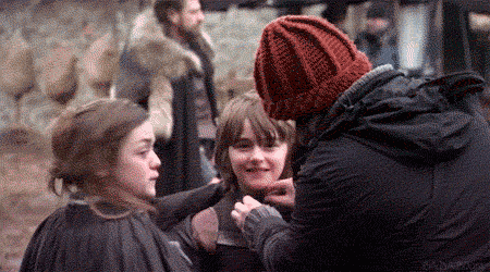 Man in Red Hat Talking to Two Girls on Movie Set